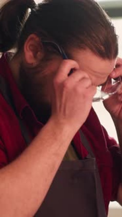 Vertical Video Carpenter Putting Safety Glasses on While Selecting Quality Wood Materials