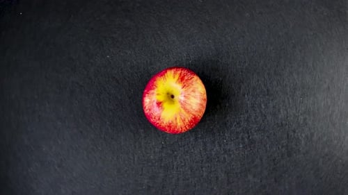 Red Apple Rotating on Black Background, Top Down Isolated Product Visual