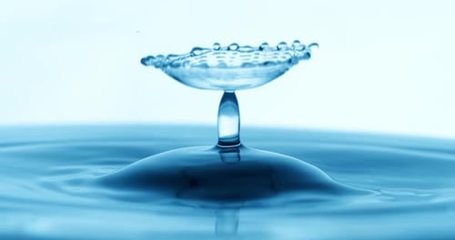 Drop of water falls into a drop of water in a super slow motion. Shot on super slow motion 1600 fps.