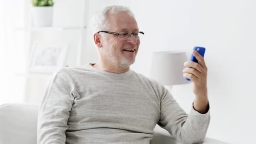 Happy Senior Man Using a Mobile Phone