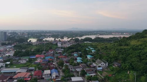 Aerial View of Houses Near the Lake in a Rural Area Next to the Road in Thailand