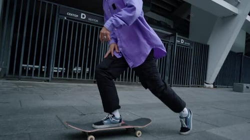 Stylish Skateboarder Rides in Urban Setting