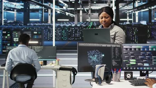 Cheerful Data Center Employee Using Node Tree Software to Analyze Datasets