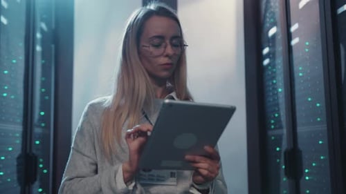 Woman works on Tablet in Server Room