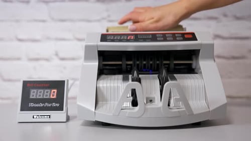 Electronic cash counting machine. Bank financial operations and calculating dollar banknotes.