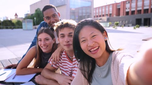 Group of Multiracial Young Academic Students Smiling and Having a Video Call or Stream Classmates