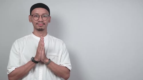 Asian Muslim man giving Eid al-Fitr greetings