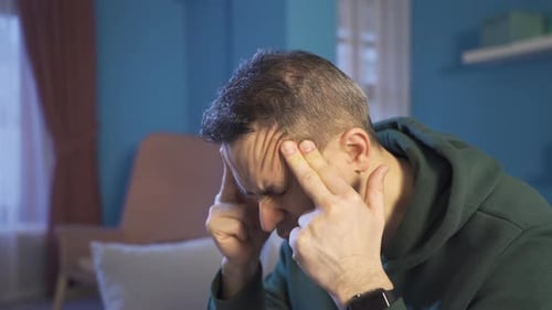 Man Massaging Temples to Relieve Headache