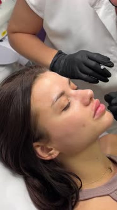 Young Woman Receives Lip Filler Injections