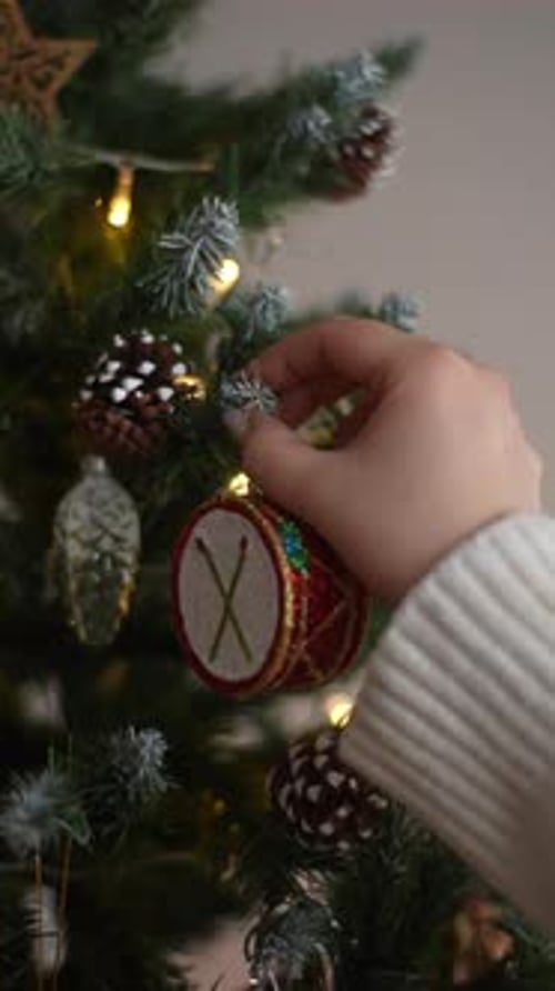 Adding Festive Drum Ornament to Christmas Tree