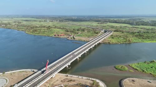 Scenic view of bridge on the river estuary with coastline on the background. Kretek II Bridge, Opak