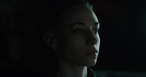 Close Up of a Woman Gazing in Dim Lighting