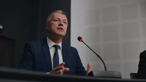 Political speaker explains leadership idea at business center convention hall