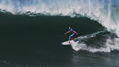 Surfer Rides a Giant Wave