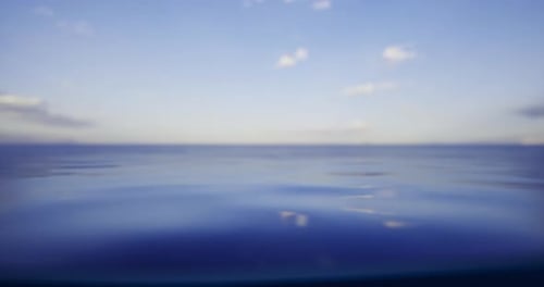 Calm Ocean Waters Reflect a Clear Sky During a Peaceful Afternoon