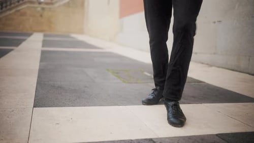 Flamenco dancer feet tapping on pavement in spain