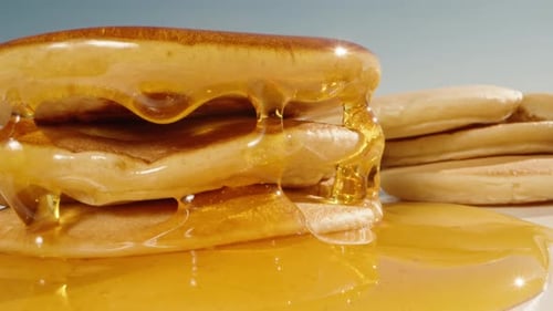 Pancakes Stacked High with Flowing Syrup