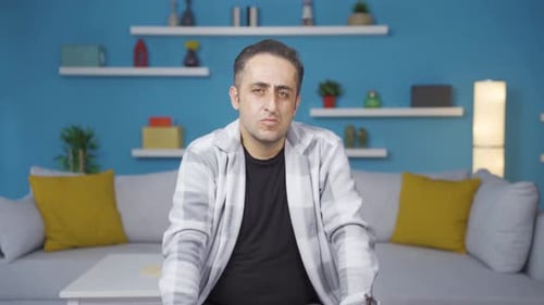 Man looking depressed at camera.