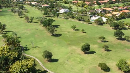 Golf Club Field with Cart and Playing Golfers
