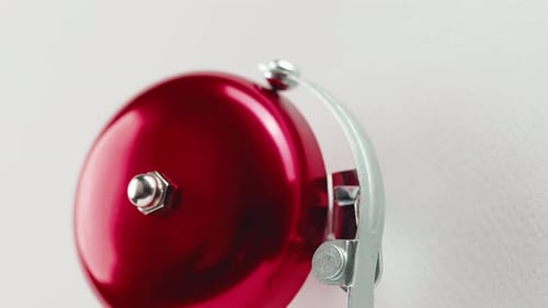 Red Fire Alarm Bell on the White Wall in a Office