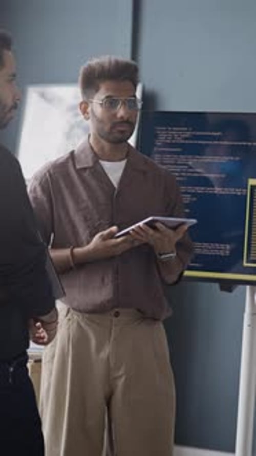 Indian IT Professionals Discussing Code on Screen in Office