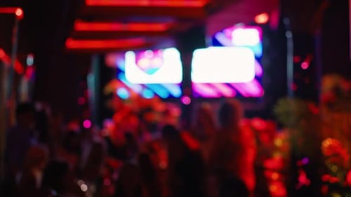 Energetic Club Crowd with Vibrant Lights at Night