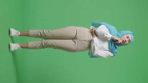 Full Body Of Asian Muslim Woman Thinking About Something And Looking Around In The Green Screen
