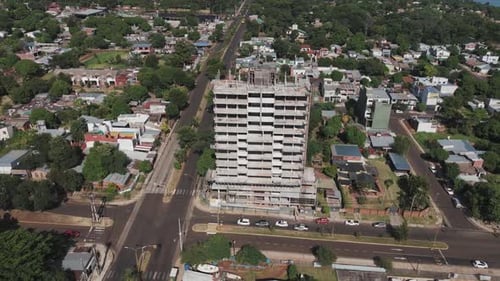 Bird's-eye drone footage provides a compelling view of a building under construction and its surroun