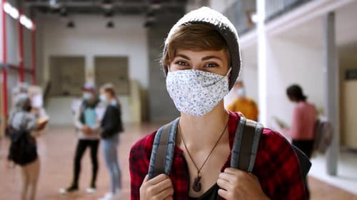 Young students with face masks return to college after coronavirus pandemic