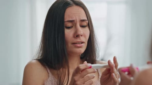 Stressed Girl Holding Pregnancy Test at Mirror Place. Close Up Scared Woman