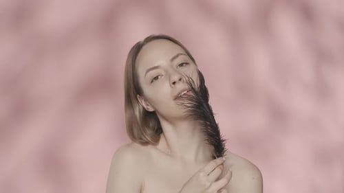 Attractive Woman Shows Off Smooth and Soft Skin While Touching Her Face and Naked Shoulders with