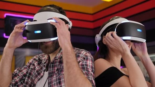 Man and Woman Using Virtual Reality Headsets