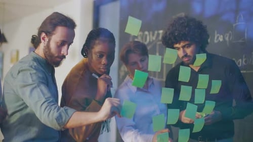 Diverse Team Collaborates on Ideas Using Sticky Notes