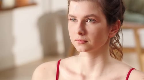 Young Woman Looking to the Side in Red Top