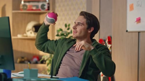 Young Men Playing with Balls in Modern Workplace