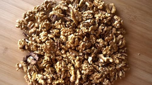 Pile of Shelled Walnuts on Wooden Surface