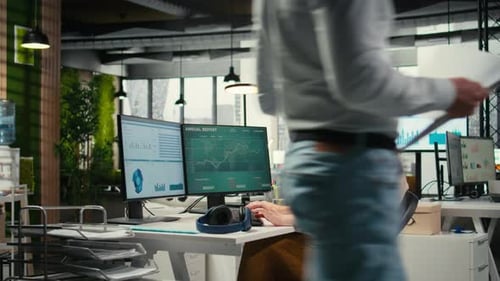 Female Executive Consultant Listening to Songs on Headphones at the Workstation