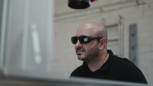 Man Wearing Tech Glasses Works in Manufacturing Workplace