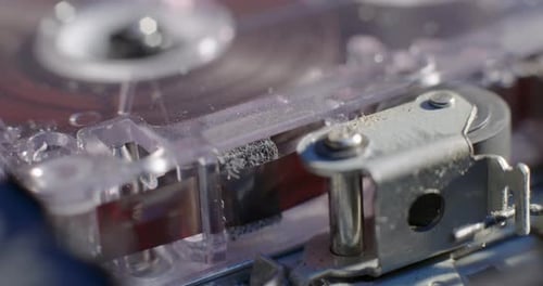 Close-Up Of Microcassette Recorder Tape Ribbon Running Through Cassette