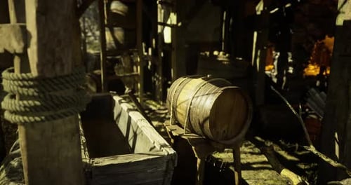 Wooden Barrel and Trough Inside a Rustic Storage Area in an Old Structure