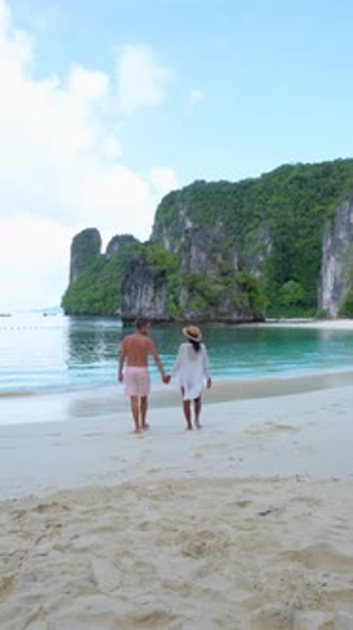 a Man and a Woman are Walking on a Beach Holding Hands Koh Hong Island Krabi Thailand