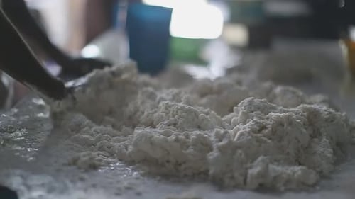 Hands Mixing Flour on Table Close Up