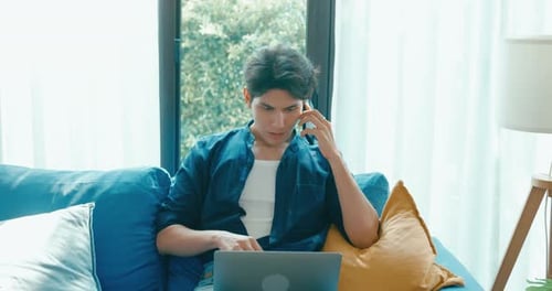 Young Adult Working From Home on Couch