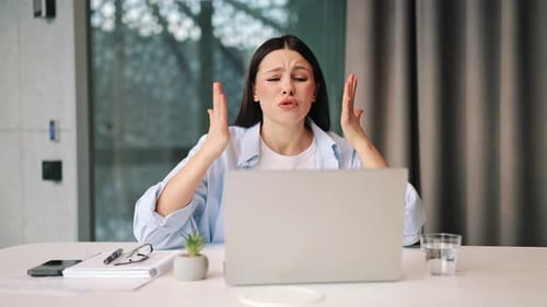 Woman Experiences Stress And Frustration While Working On Laptop