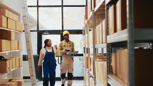 Group of People Using Laptop in Warehouse Space