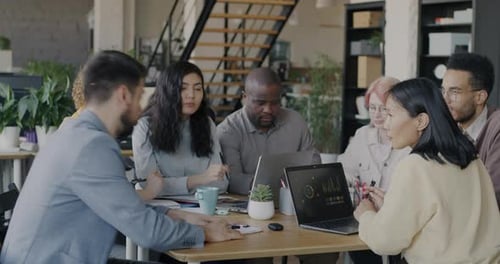 Multicultural Group of People Talking Working Together Concentrated on Business Meeting in Office