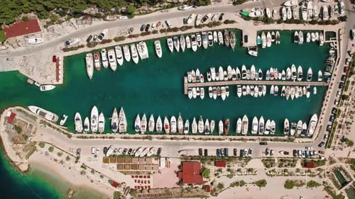 Sailing Vessels docked in harbor. Aerial view of marina brimming with boats ready for sea voyages in