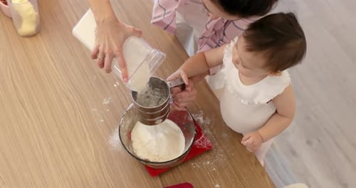 Woman and Baby Cooking Together at Home