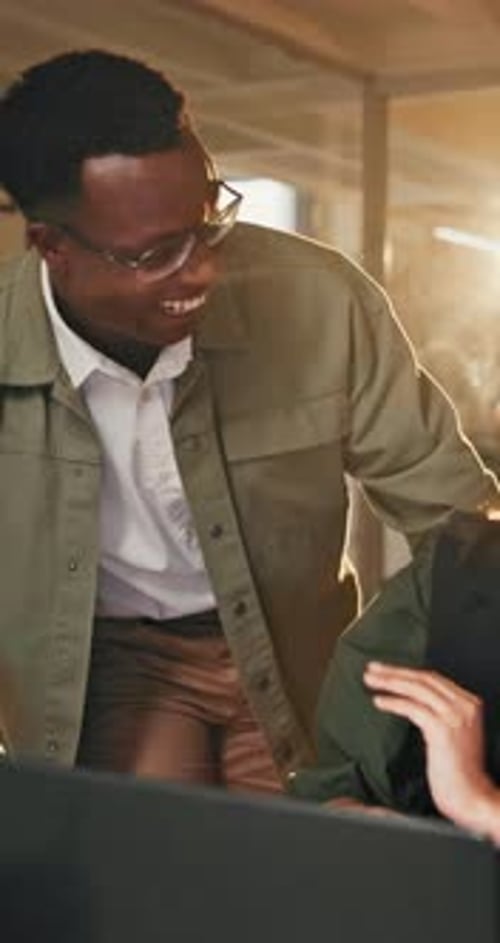 Colleagues Celebrating Success with a High Five at Work