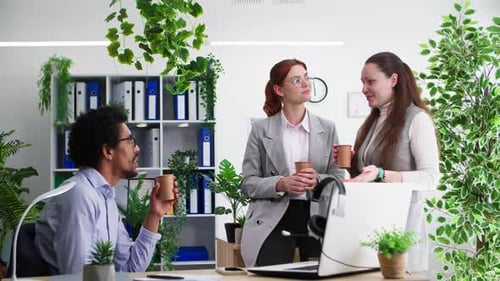 Workplace Relationships Friendly Female and Male Colleagues Chatting During Coffee Break in Office